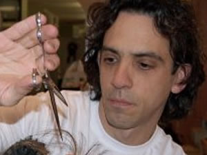 Andrew DiSimone cutting a wig